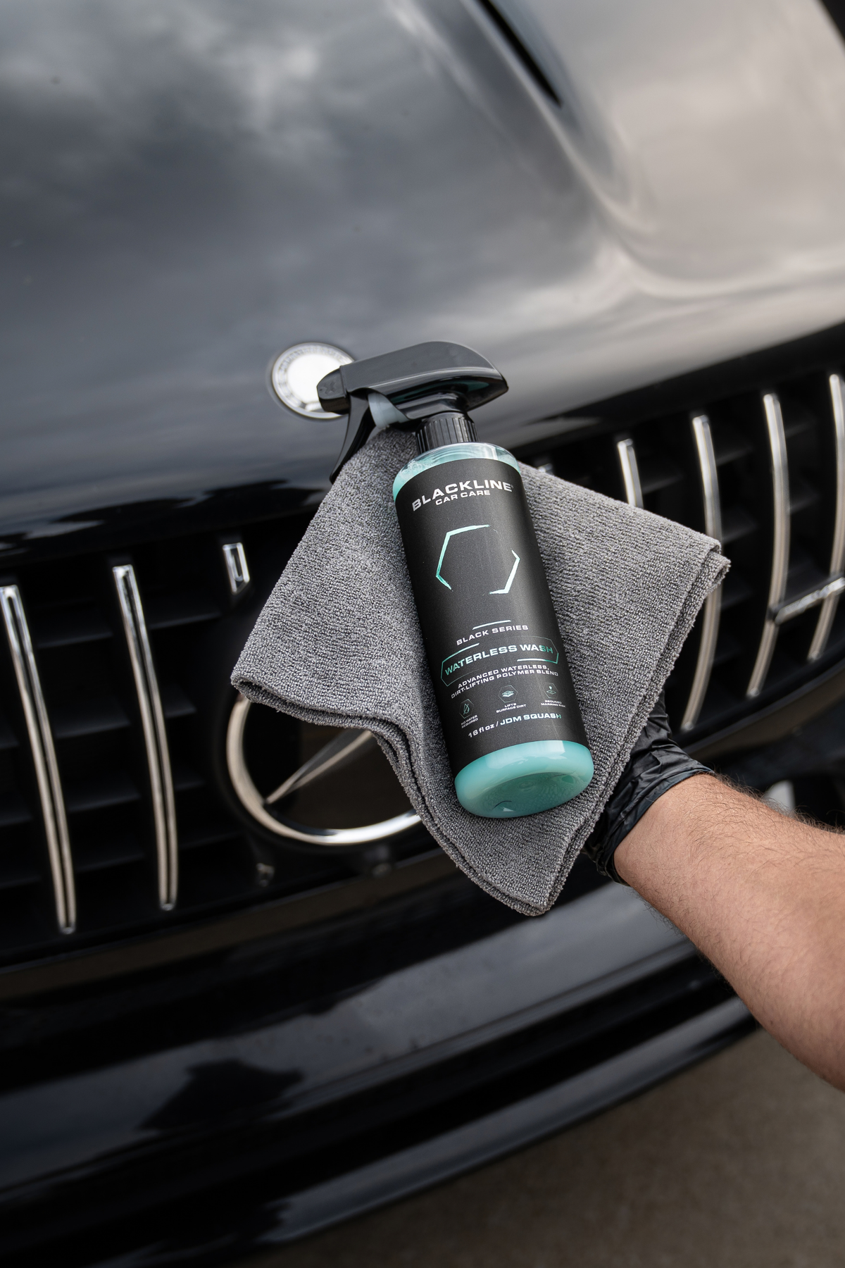 Blackline Waterless Wash being sprayed onto vehicle paint for a no-rinse waterless clean