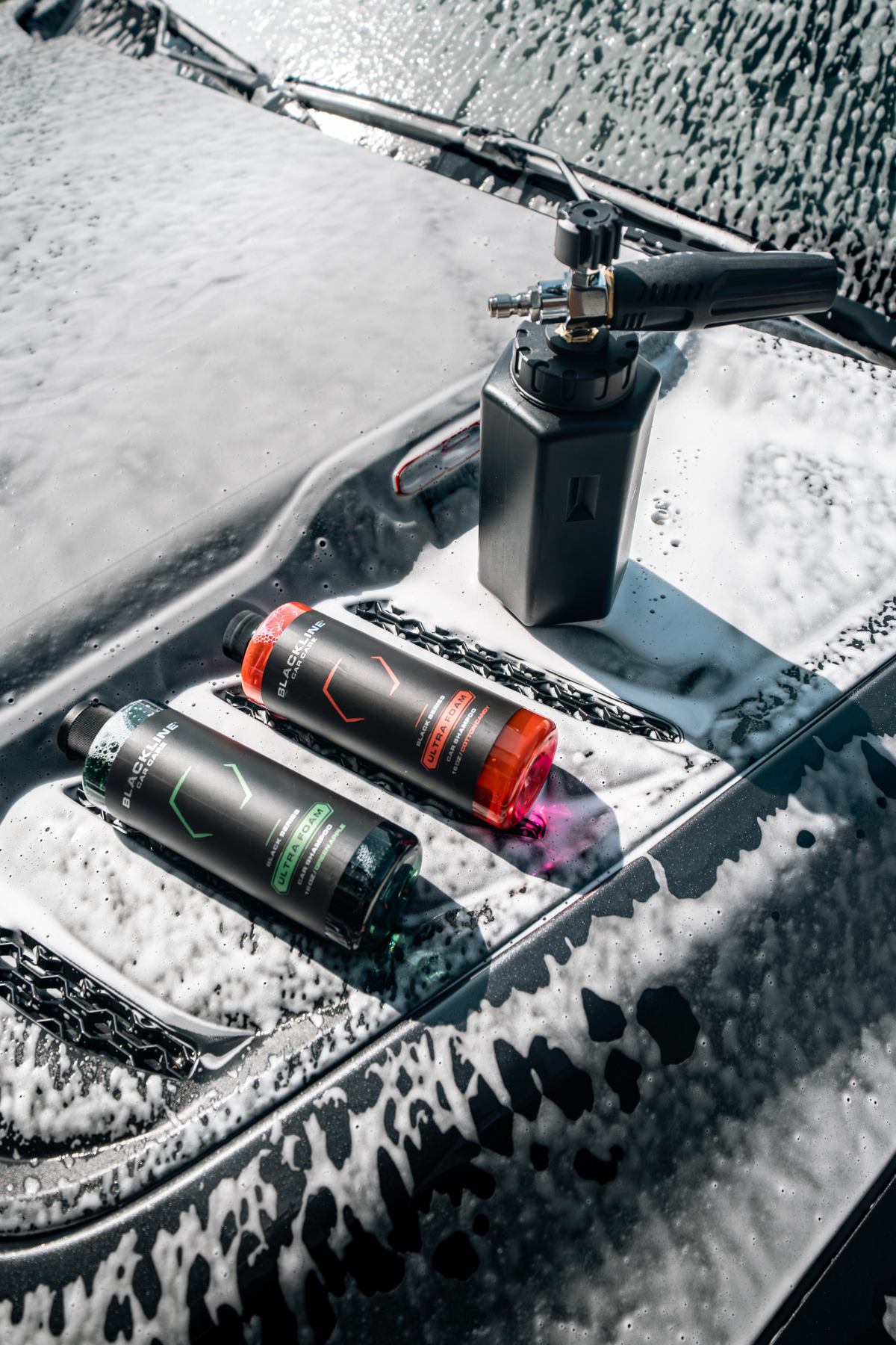 Foam cannon and Ultra Foam being used on a vehicle, lifestyle composition.
