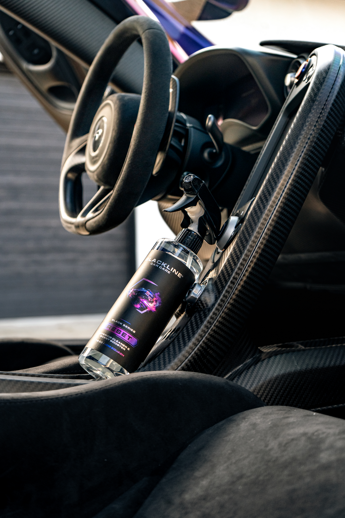 Lifestyle photo of Blackline Reset interior cleaner inside a vehicle.