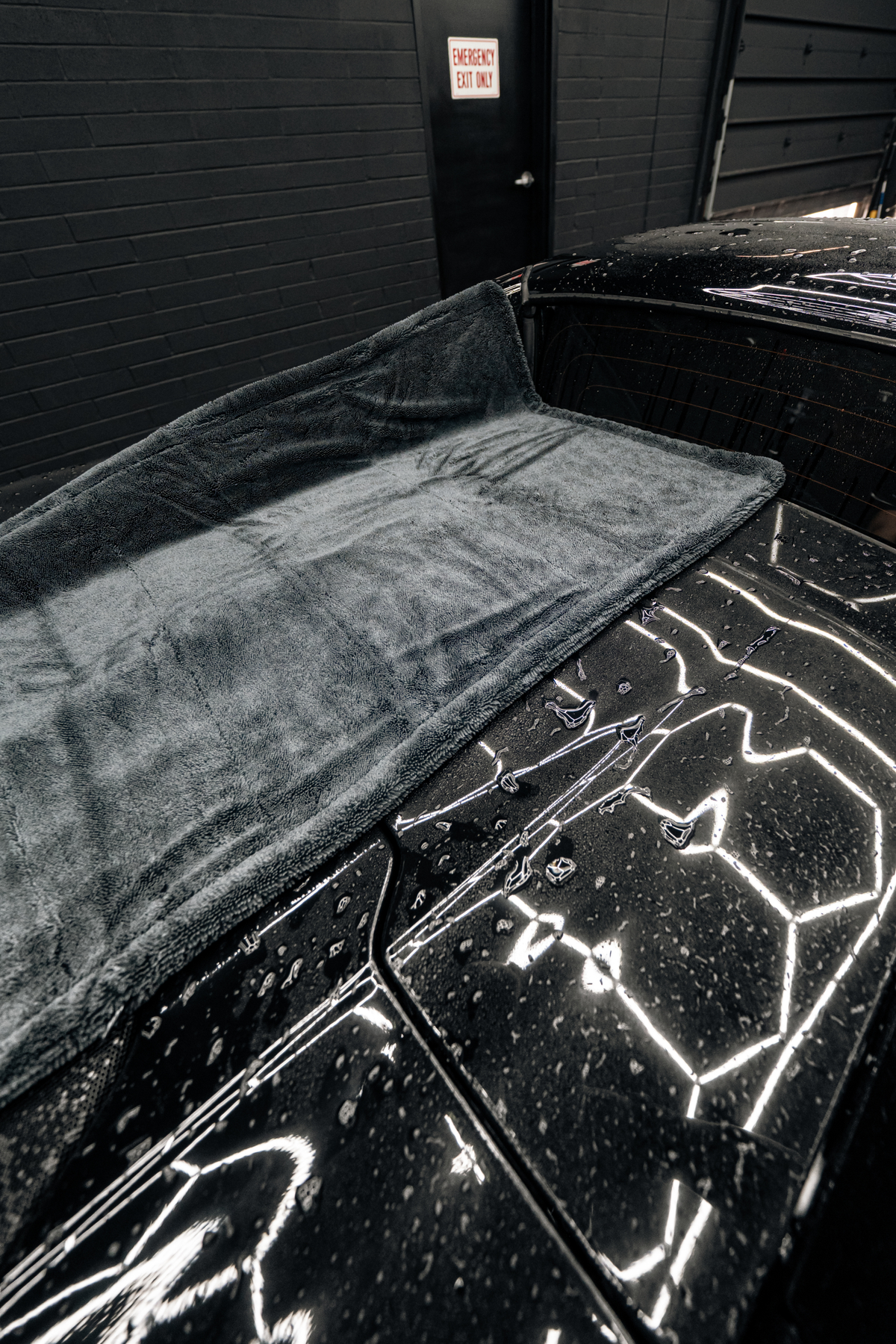 Drying towel in use on a vehicle from the Care Bundle.