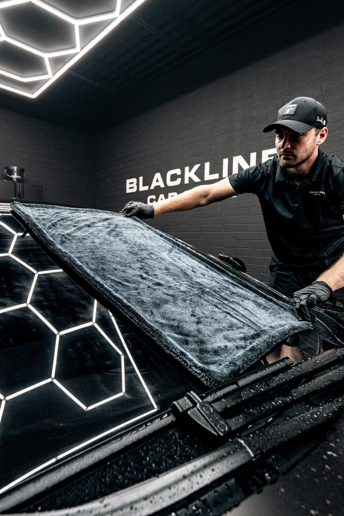 Drying towel wiping a windshield, Care Bundle lifestyle.