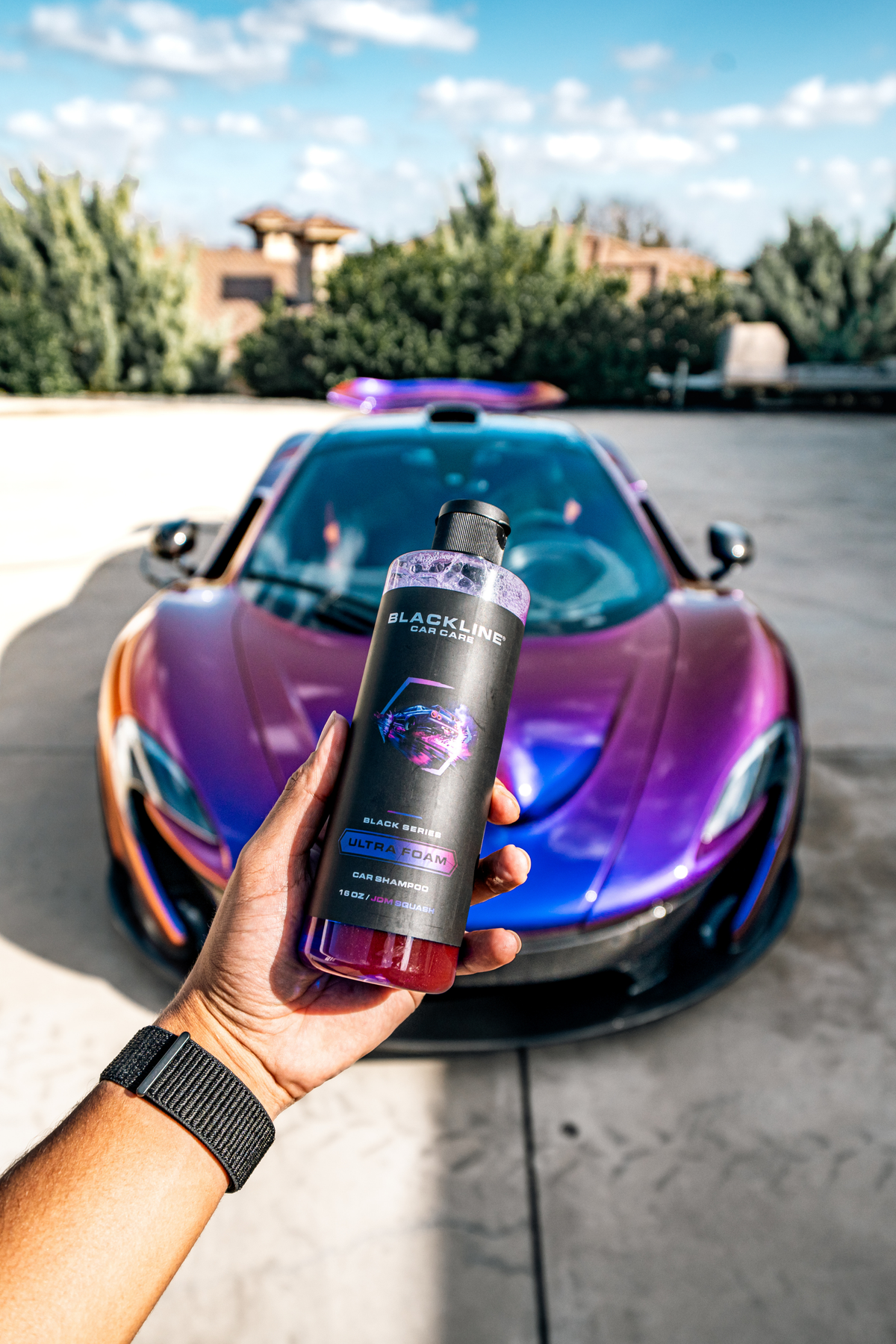 Blackline Ultra Foam JDM Squash 16oz bottle photographed at an angle, showing the matte black label and purple bottle cap.