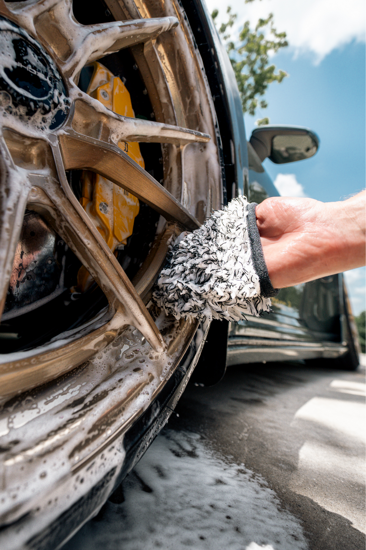 Close-up of Blackline Wheel Mitt cleaning wheel detail.