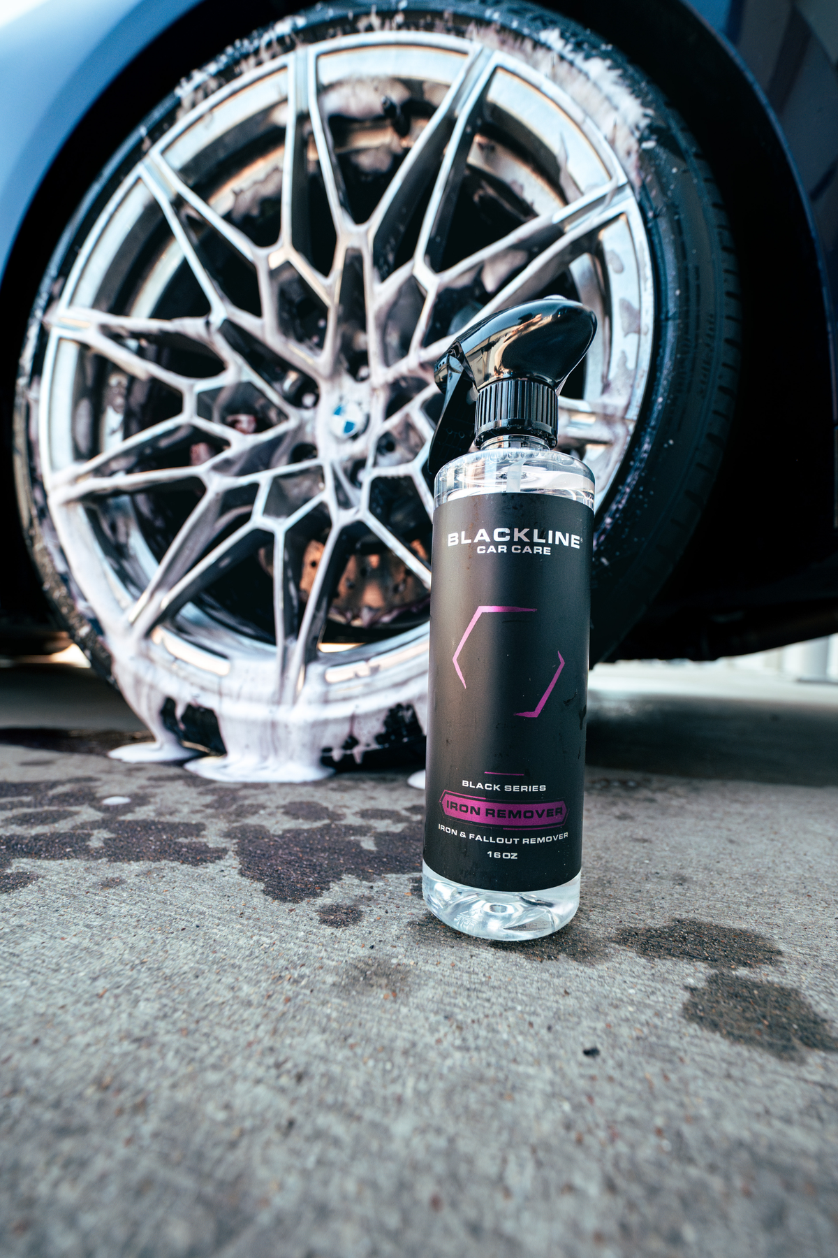 Lifestyle photo of Blackline Iron Remover bleeding purple as it reacts with iron particles on vehicle paint.