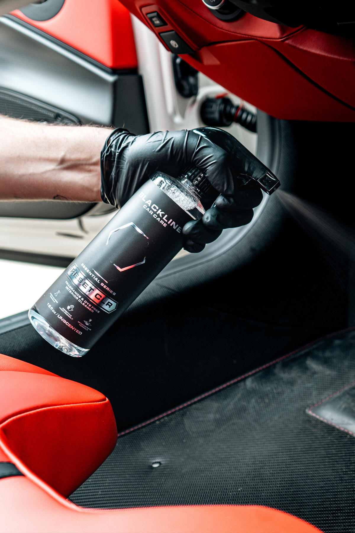 Blackline Reset CLR interior cleaner sprayed onto a car interior surface