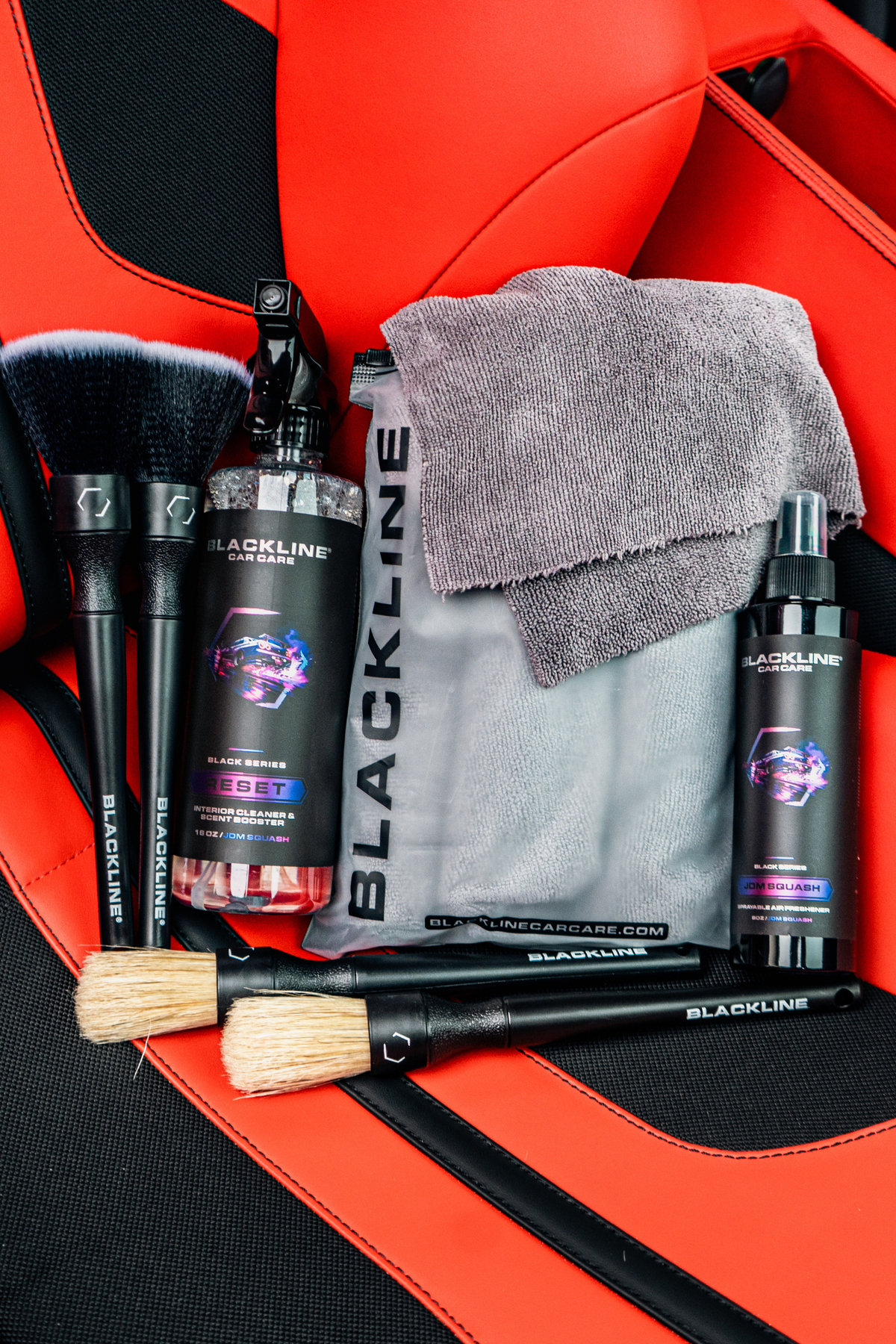 Blackline Reset JDM Squash scent full experience kit displayed on a Ferrari F12 seat.