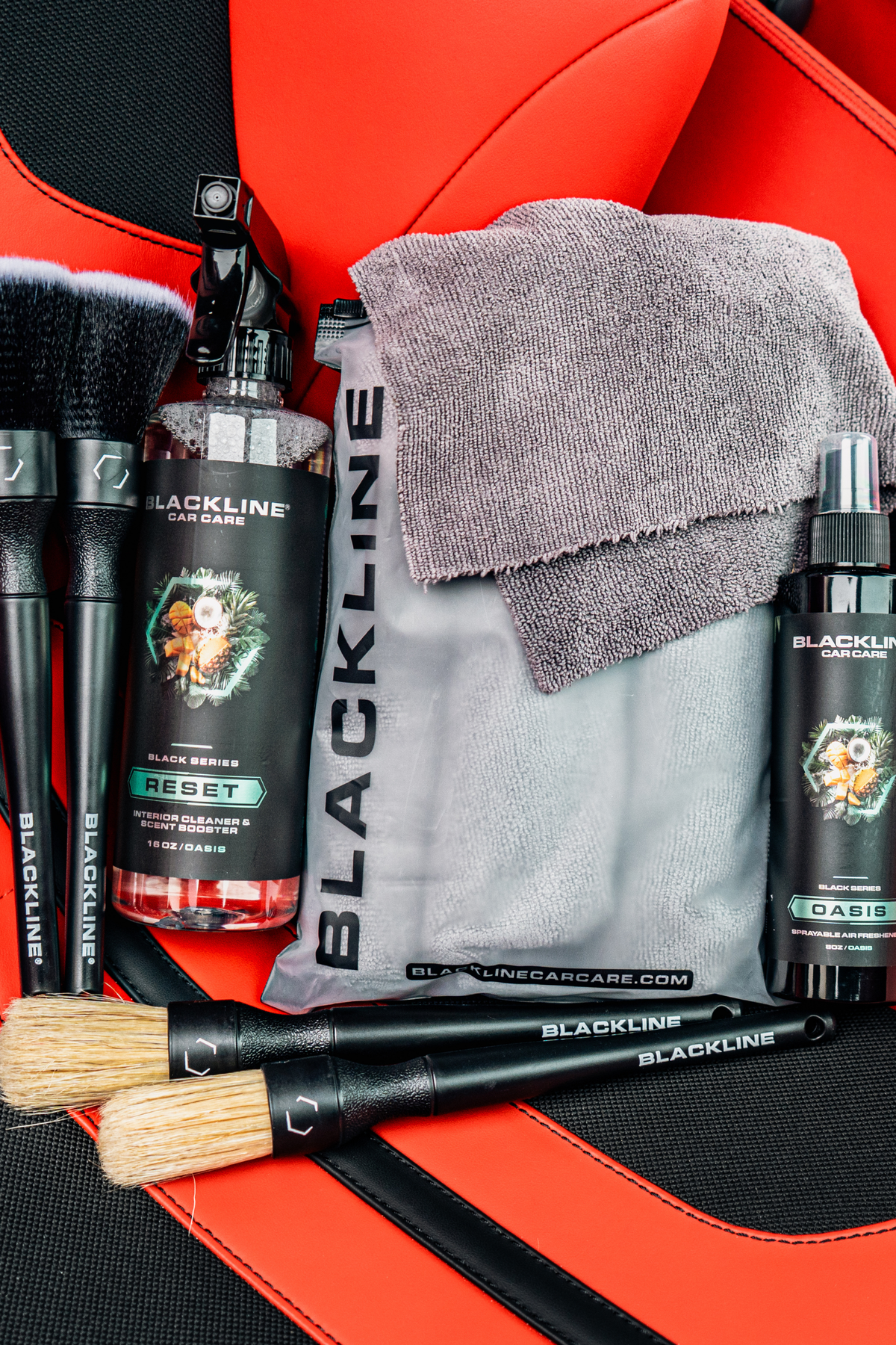 Blackline Reset Oasis scent full experience kit displayed on a Ferrari F12 seat.
