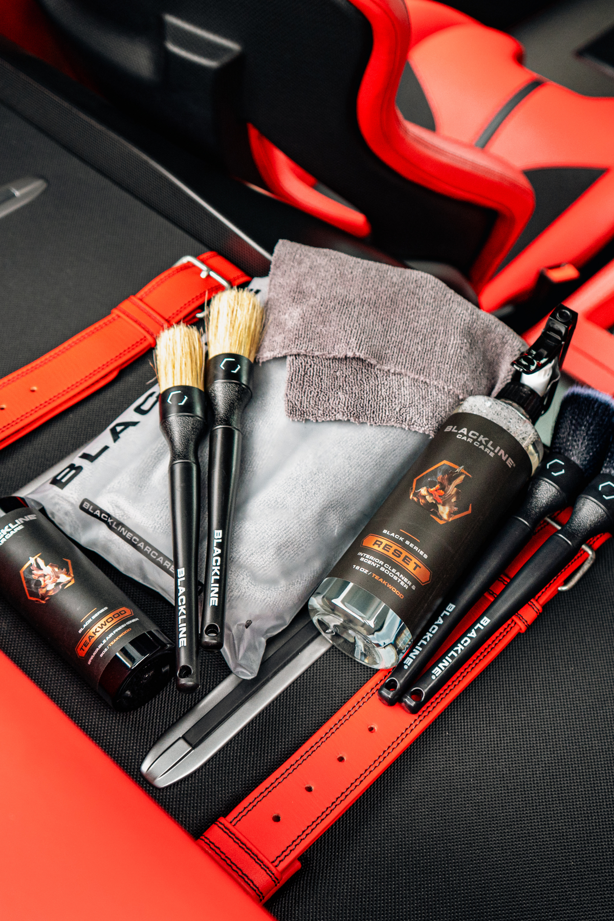 Blackline Reset Teakwood full experience kit displayed in a Ferrari F12 trunk