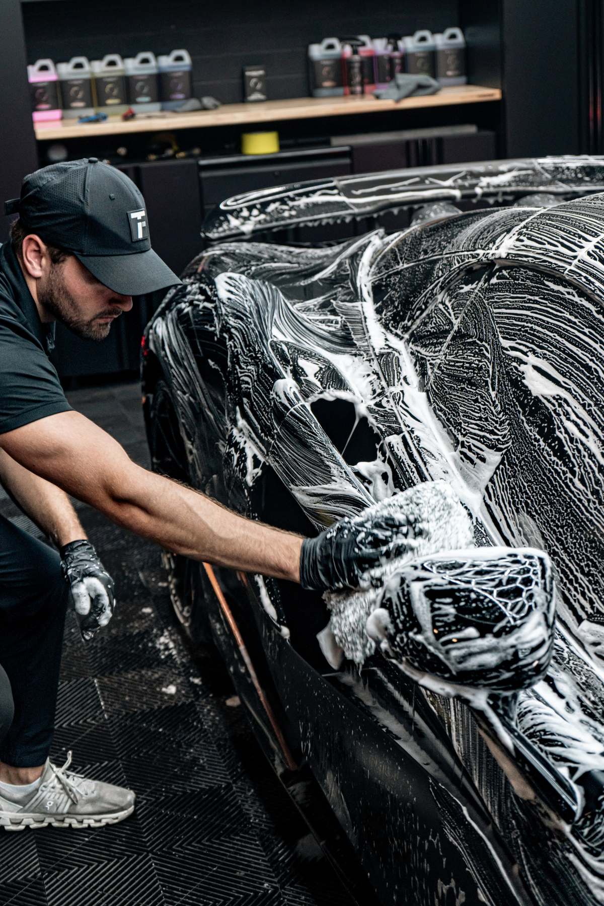 Blackline Microfiber Wash Mitt actively washing a car door panel with suds.