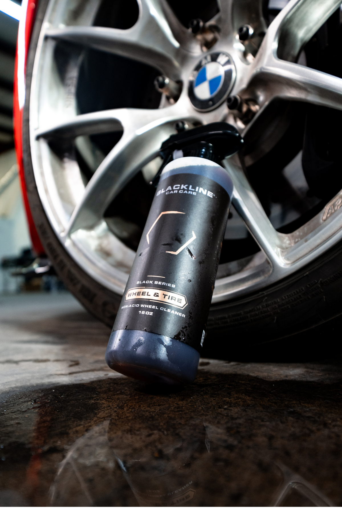 Close-up of the Blackline Wheel n Tire Cleaner bottle on a wheel.