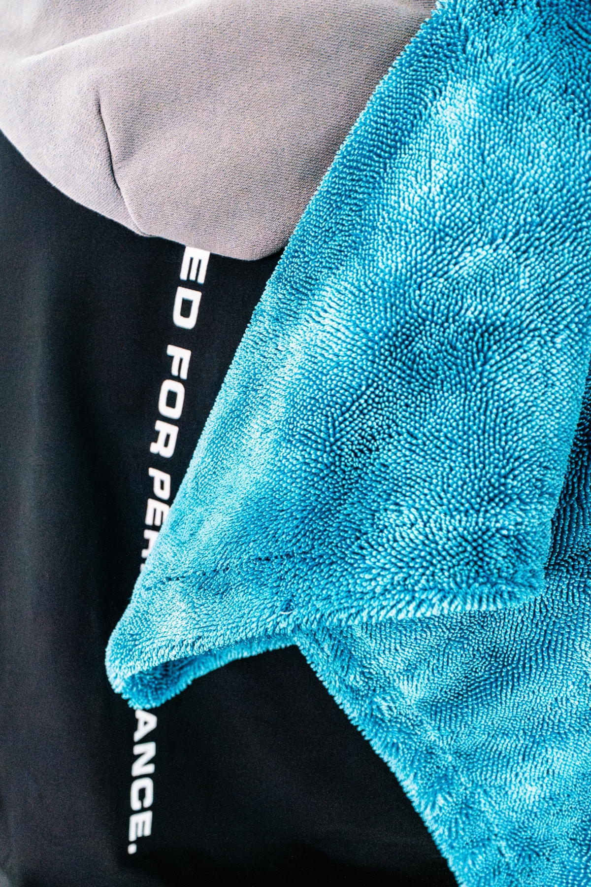 Blackline Twisted-Loop Drying Towel folded with product packaging on white background