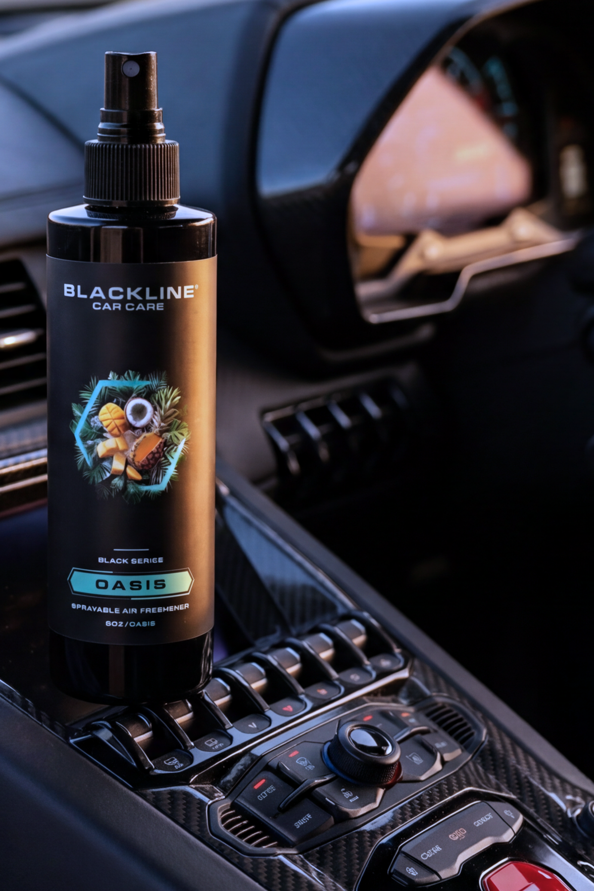 Hand spraying Blackline Dark Ice air freshener mist inside a vehicle interior.