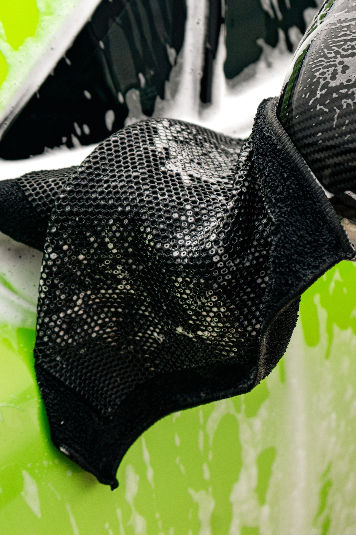 Blackline synthetic clay towel in use during paint decontamination on a vehicle.