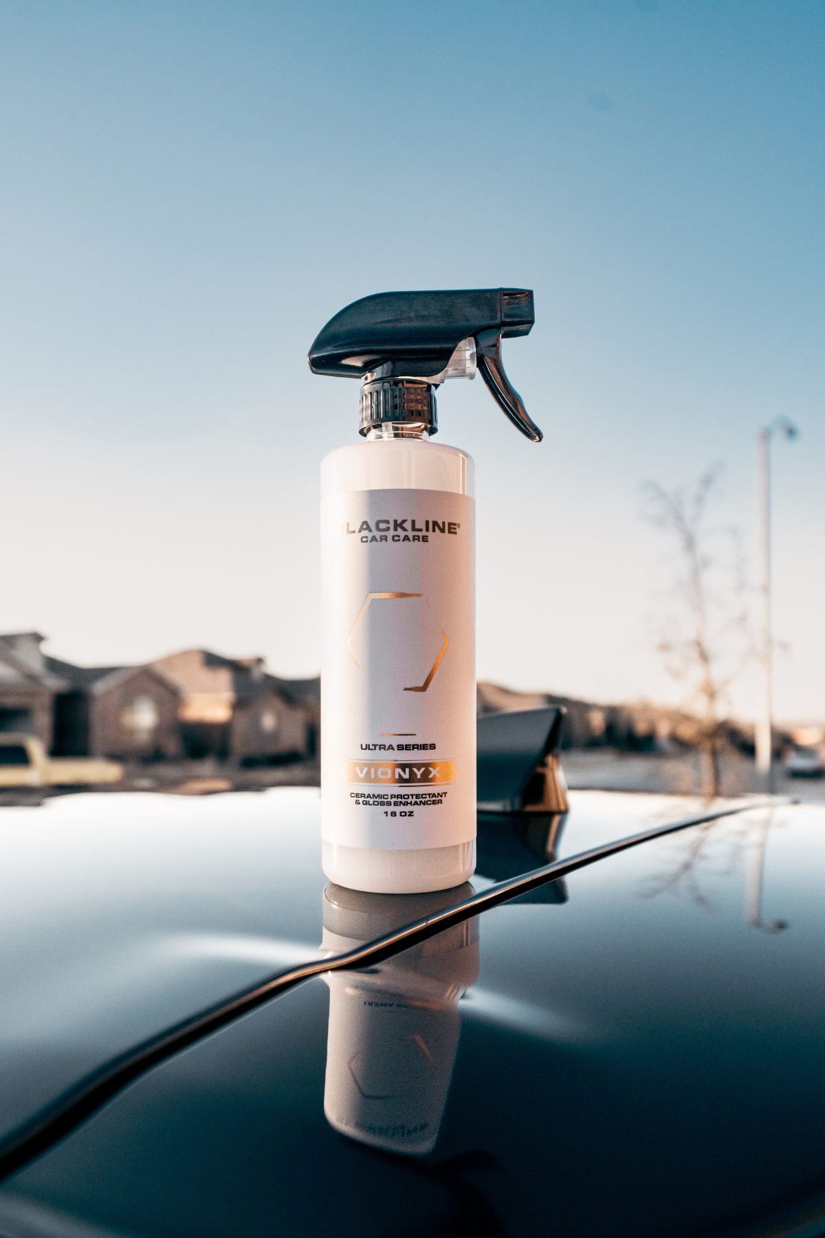 Blackline Vionyx ceramic spray being buffed onto a car surface.