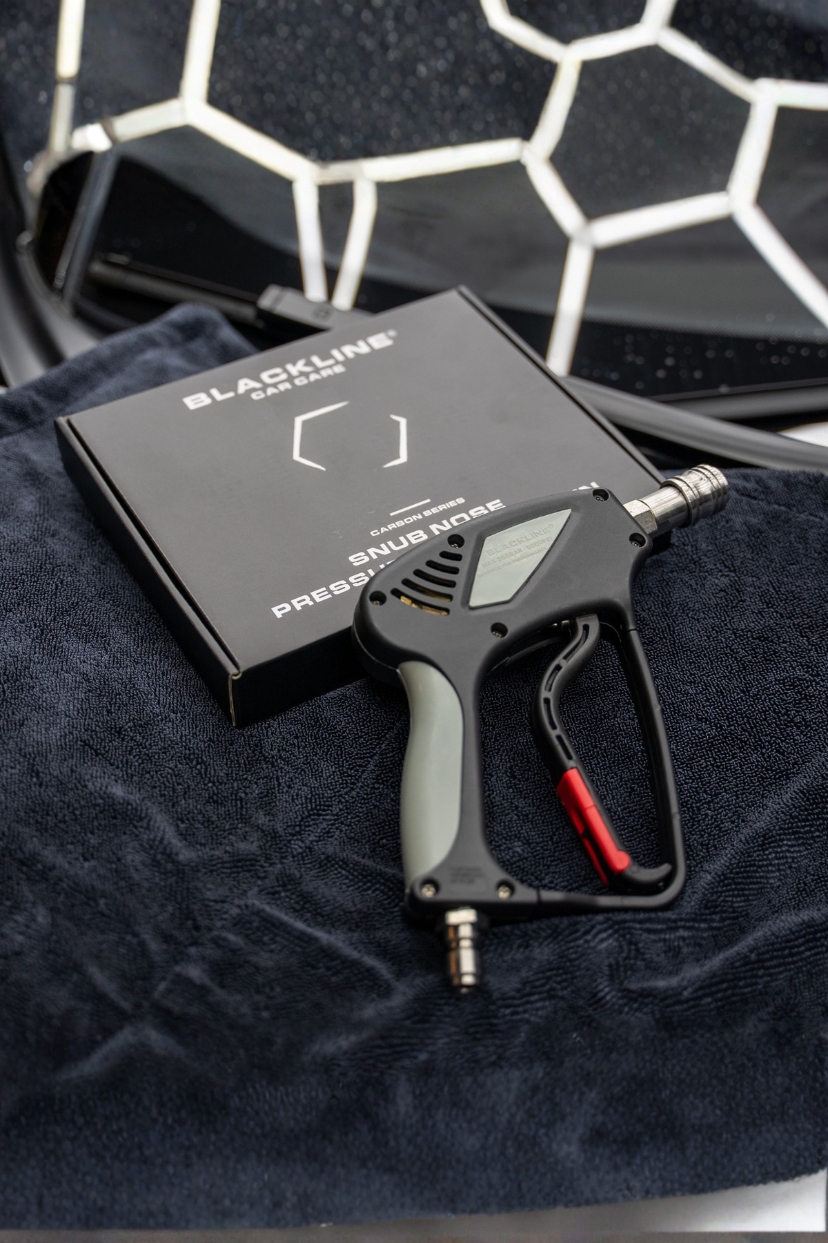 Snub-Nose Pressure Washer Gun in use during a vehicle wash.