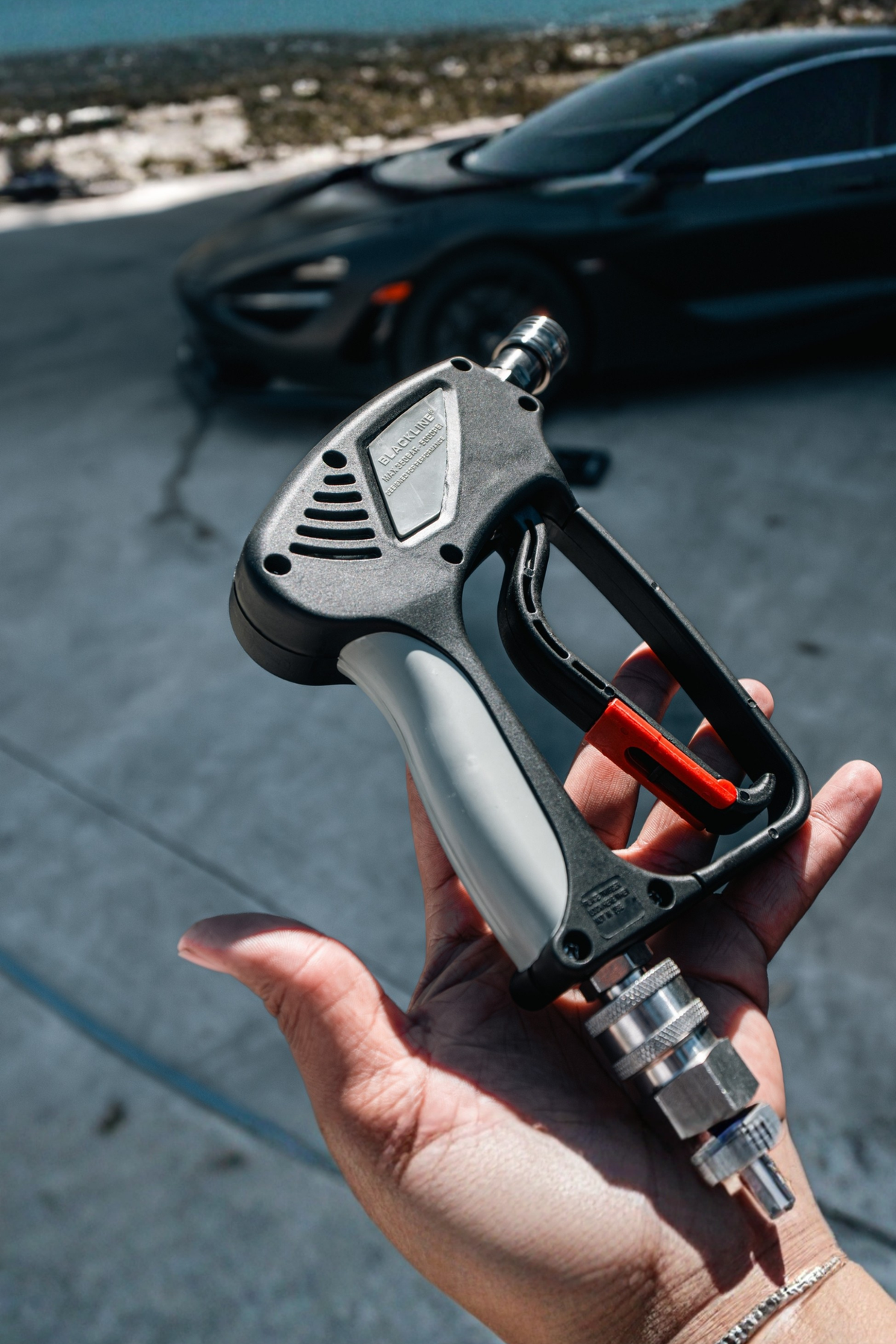 Snub-Nose Pressure Washer Gun spraying water during use.
