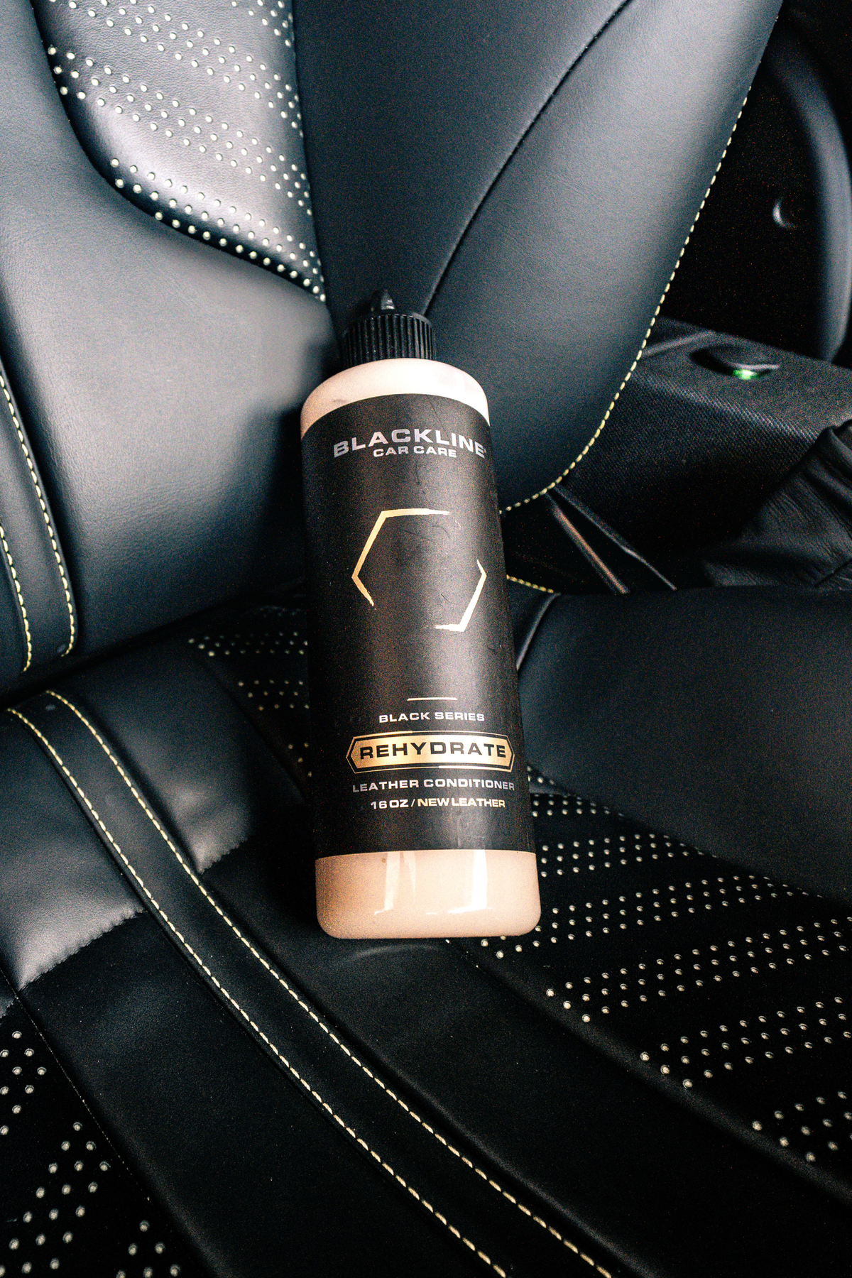 Leather seat being buffed after Blackline Rehydrate Leather Conditioner application.
