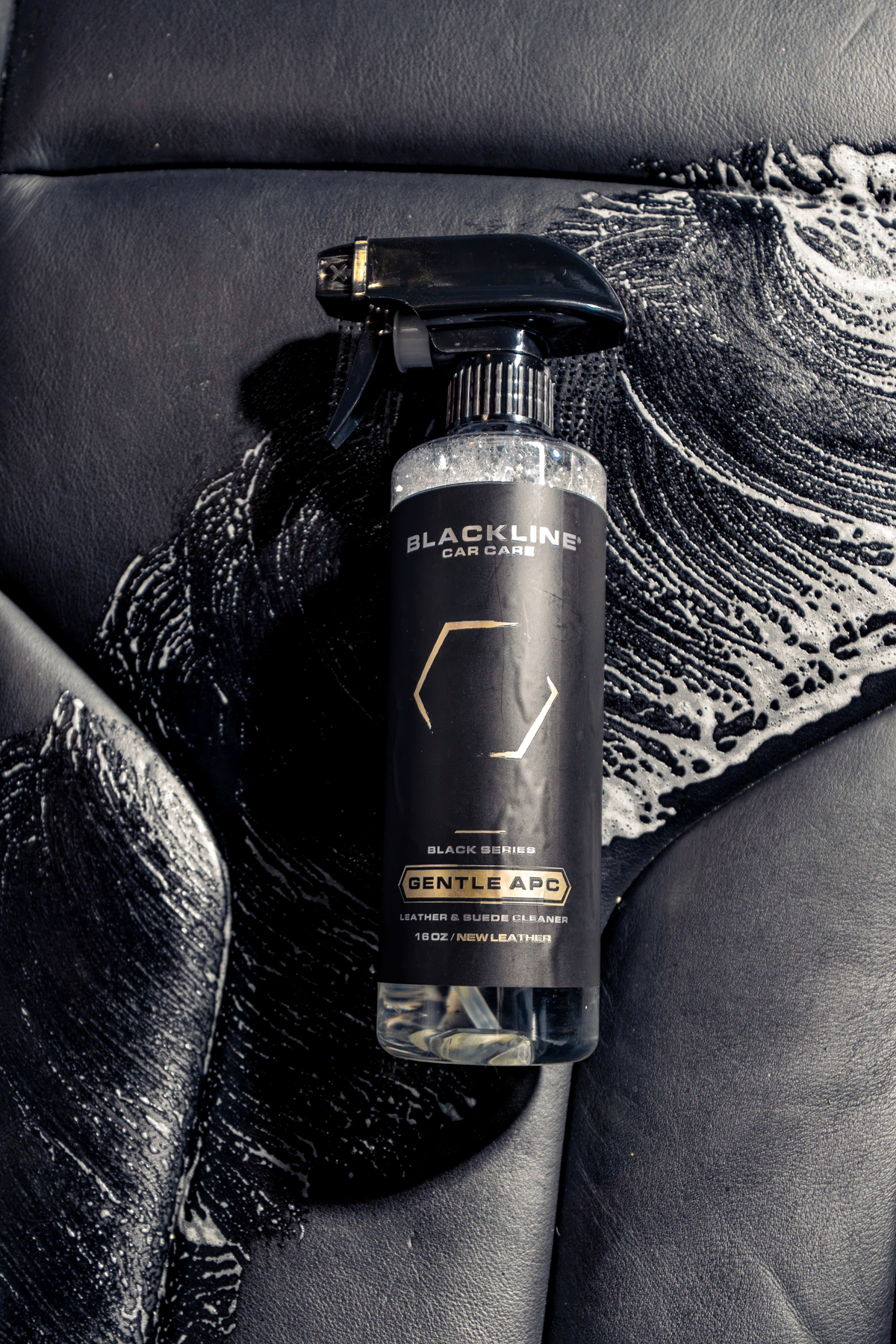 Hand applying products from the Blackline Leather Bundle to leather.