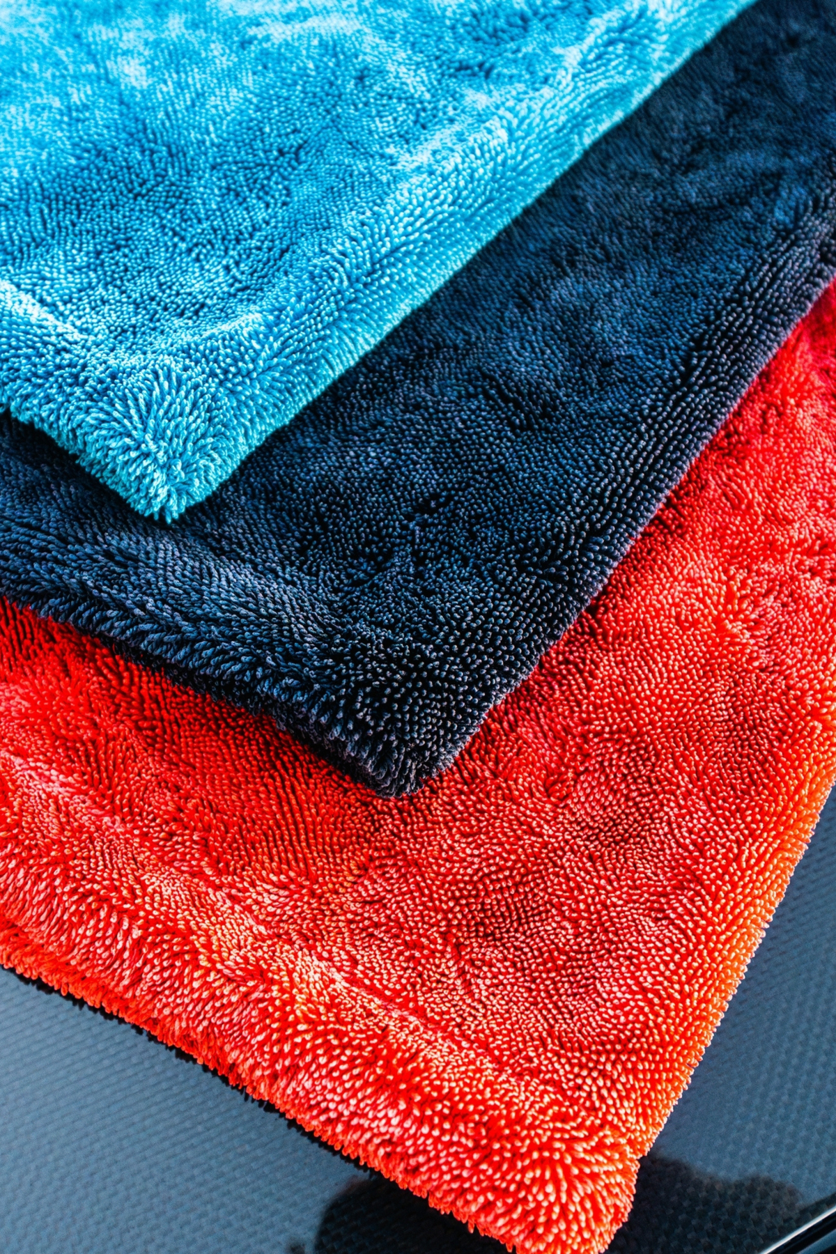 Blackline Microfiber Kit towels arranged with detailing supplies.