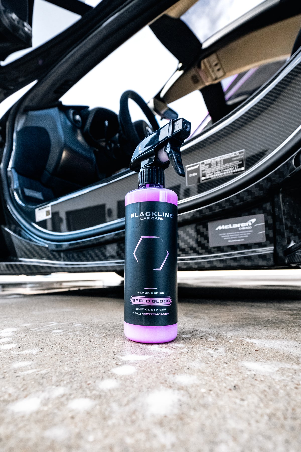 Lifestyle shot of Blackline Speed Gloss Quick Detailer being applied to a car body panel.