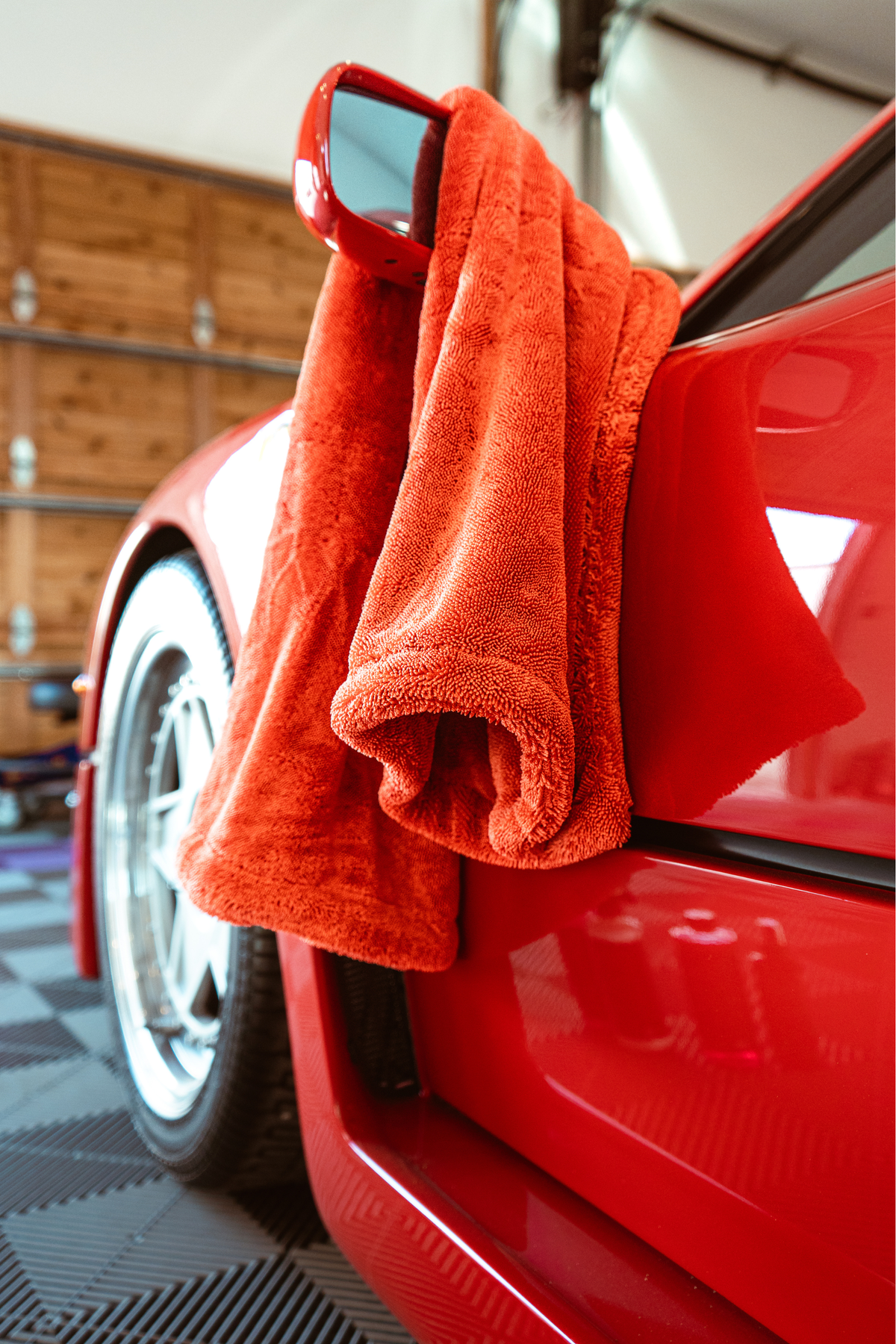 Red drying towel on a red Ferrari F40 side mirror.