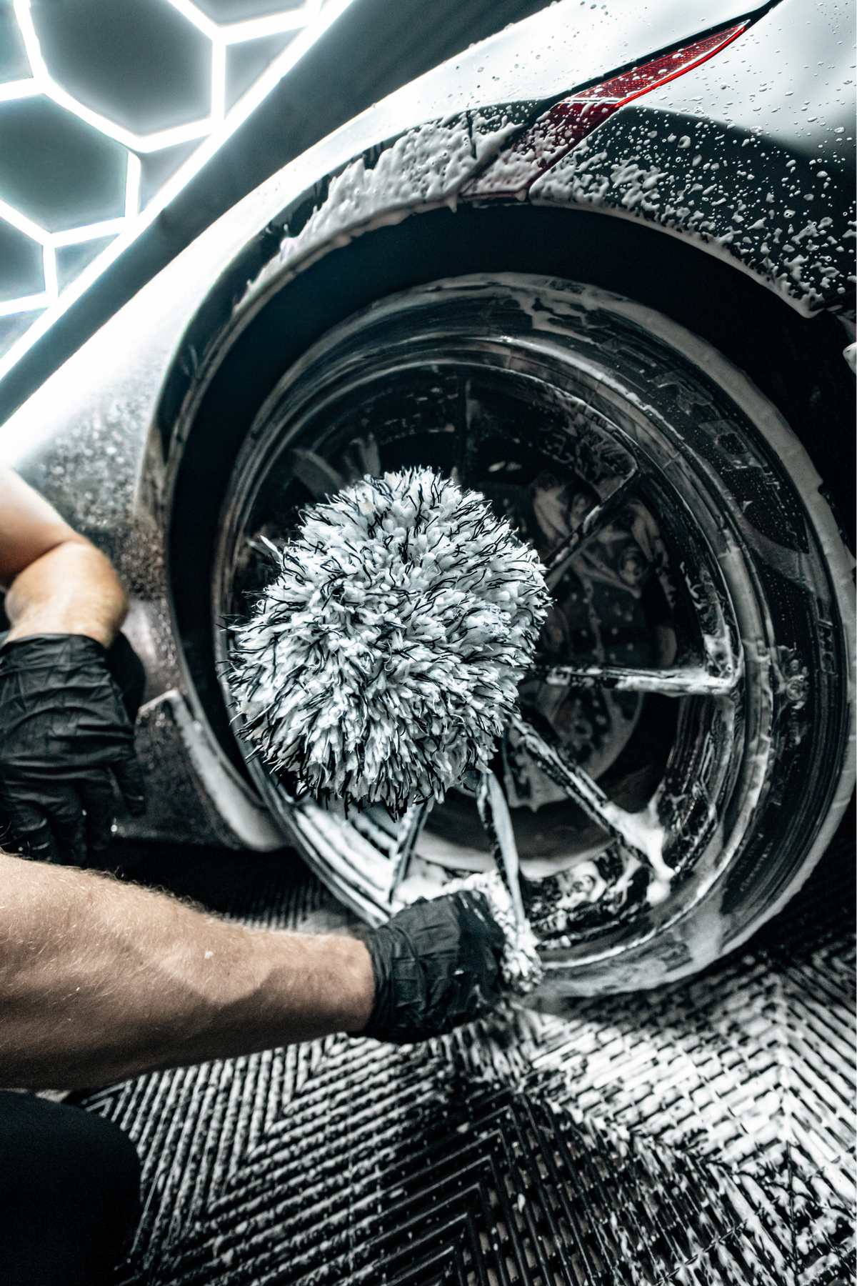 Action shot of Blackline Wheel Mitt scrubbing a wheel.