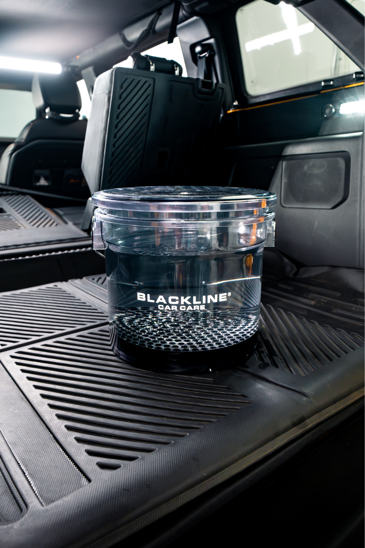 Lifestyle shot of Blackline Detailing Bucket with wash supplies.