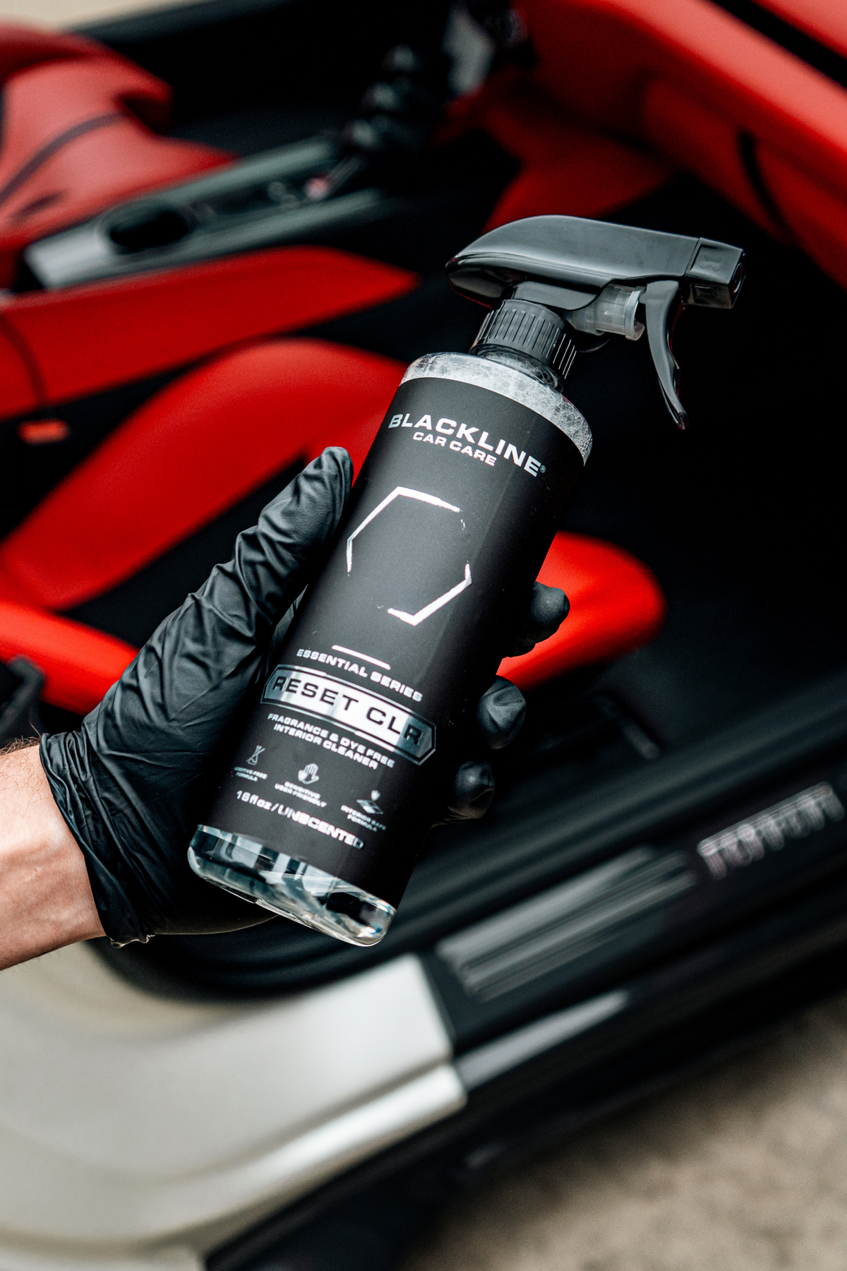 Blackline Reset CLR interior cleaner spray bottle held in hand