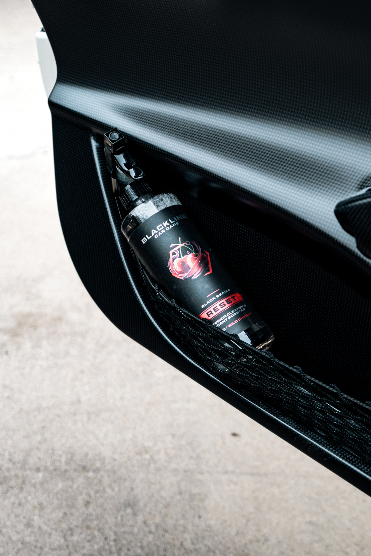 Blackline Reset Wild Cherry interior cleaner applied to a car door panel