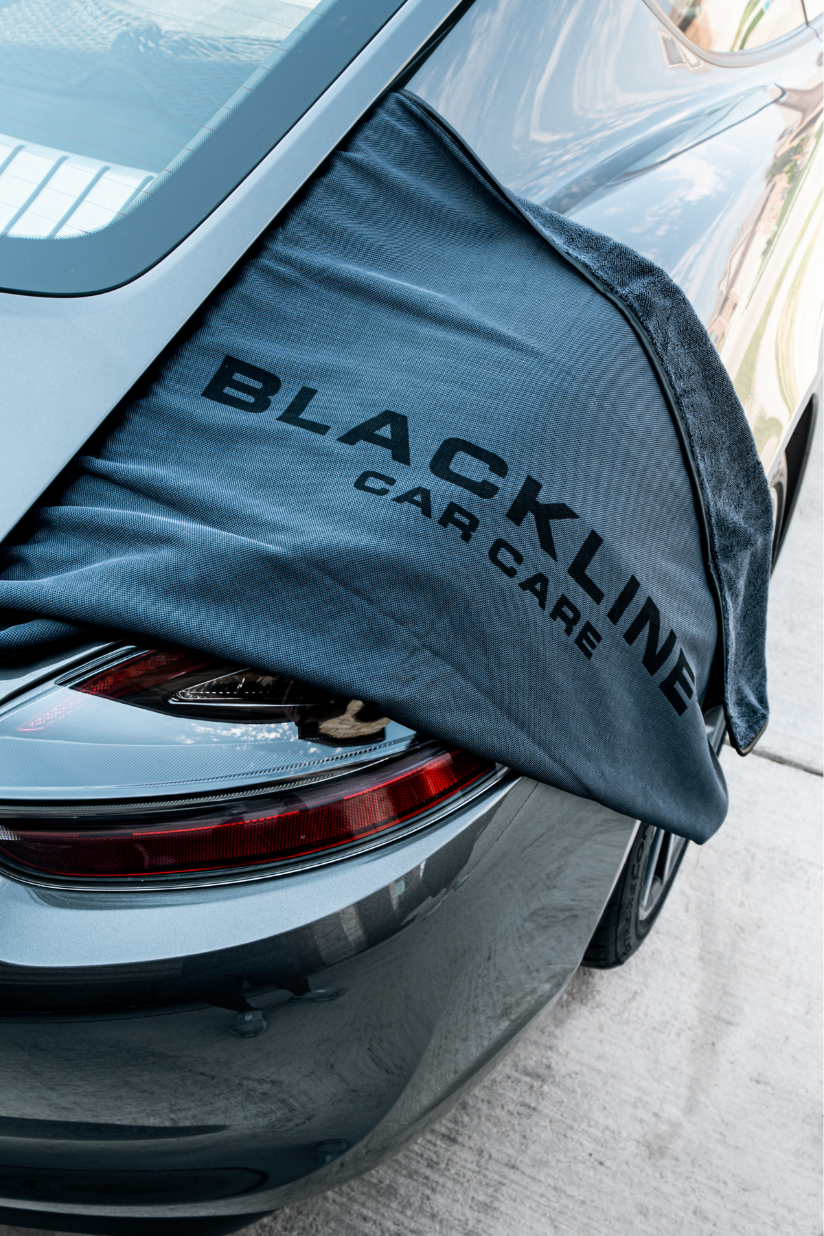 Blackline Slim Drying Towel being used to dry a car trunk panel.