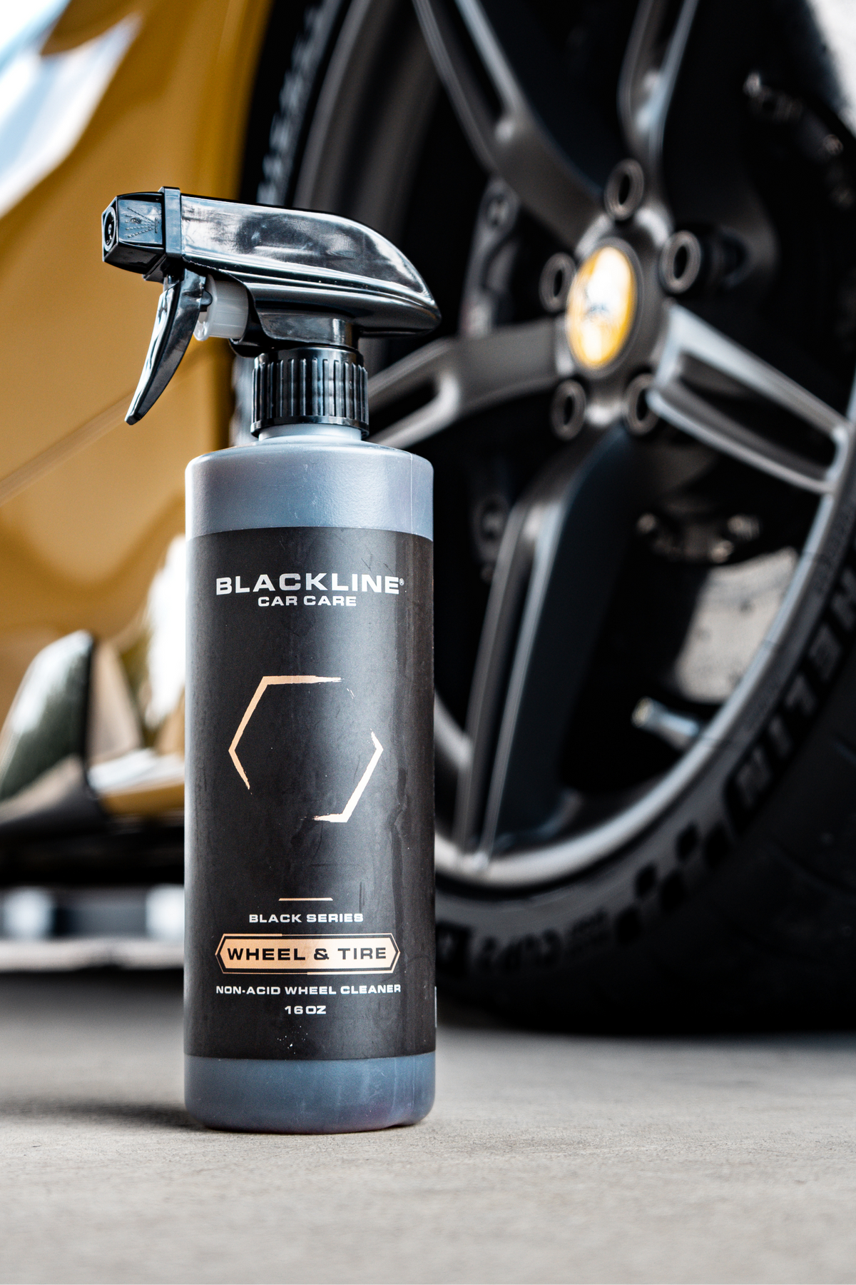Lifestyle photo of Blackline Wheel n Tire Cleaner being used during a wheel detail.